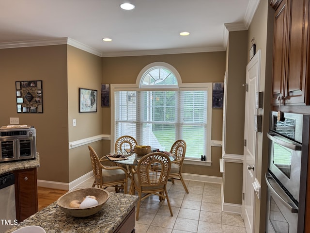 dining room featuring baseboards, crown molding, and recessed lighting