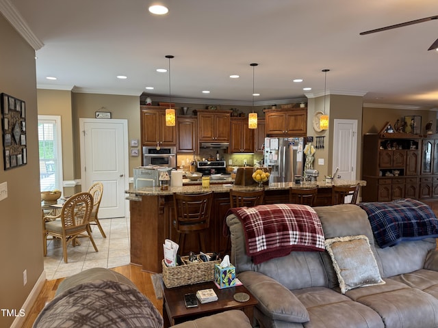 living area featuring recessed lighting, a ceiling fan, and crown molding