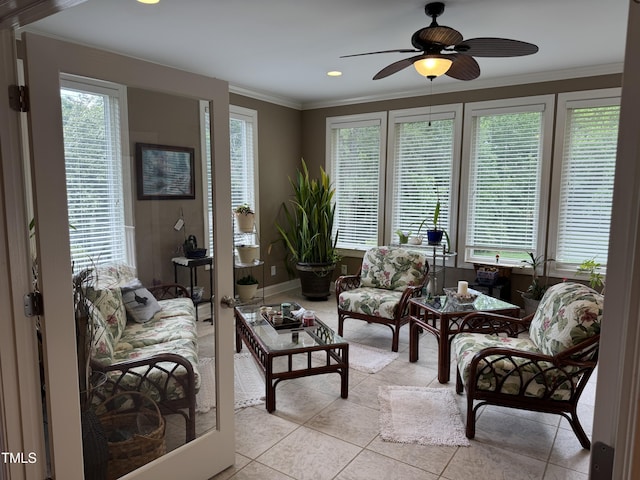living area with light tile patterned flooring, ceiling fan, plenty of natural light, crown molding, and recessed lighting
