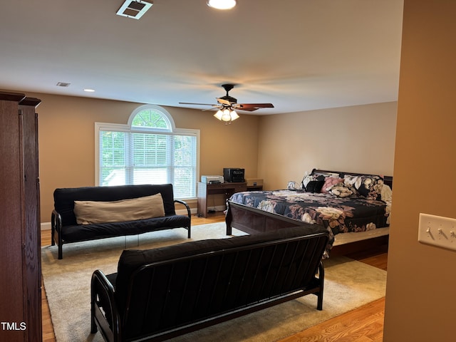 bedroom with wood finished floors, recessed lighting, and a ceiling fan