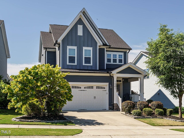 view of front of home featuring board and batten siding, concrete driveway, an attached garage, and a shingled roof