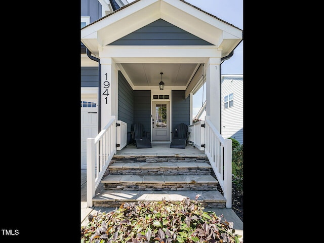 view of exterior entry with covered porch and board and batten siding