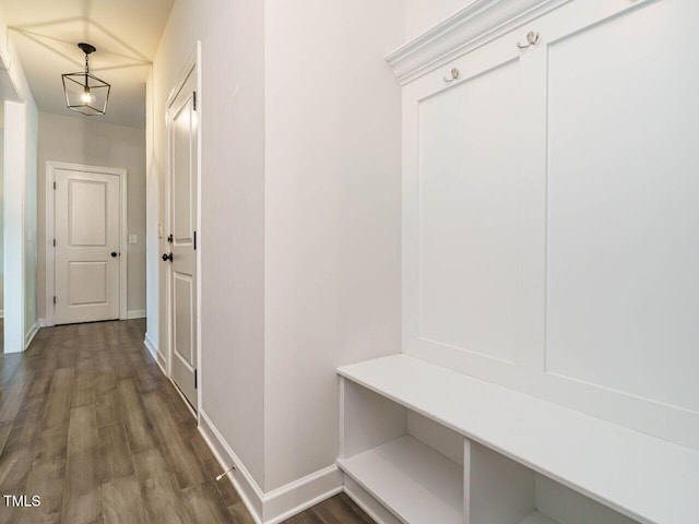 mudroom featuring baseboards and wood finished floors