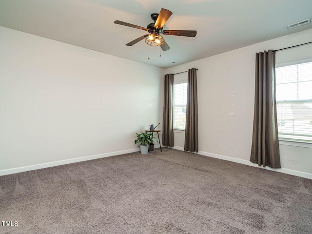 spare room with carpet floors, ceiling fan, and baseboards