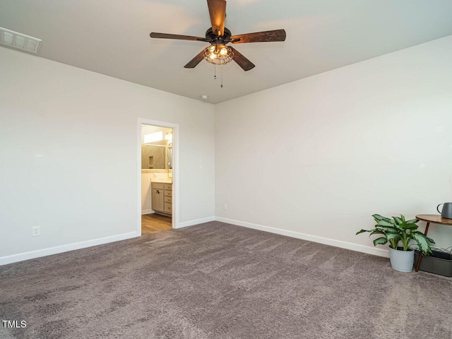 carpeted spare room with baseboards and a ceiling fan