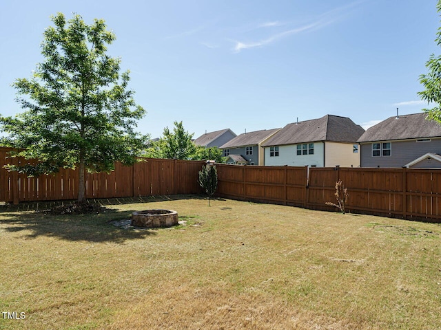 view of yard with a fire pit