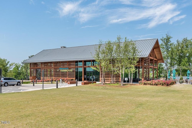 surrounding community with a lawn and uncovered parking