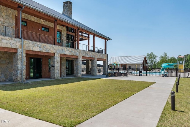 view of property with fence and a community pool