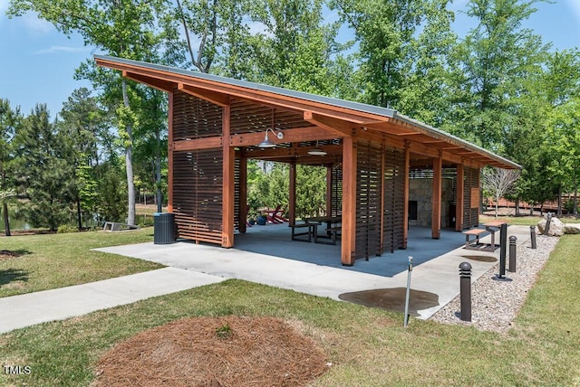 view of community with a lawn and a patio area