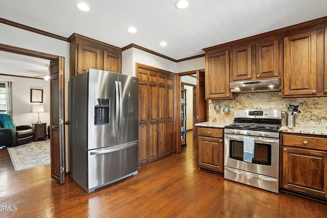 203 Marlowe Dr, Dunn, NC 28334 - kitchen with stainless steel appliances, under cabinet range hood, ornamental molding, dark wood finished floors, and decorative backsplash