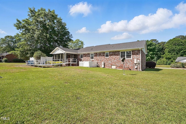 203 Marlowe Dr, Dunn, NC 28334 - back of house with a sunroom, brick siding, and a lawn