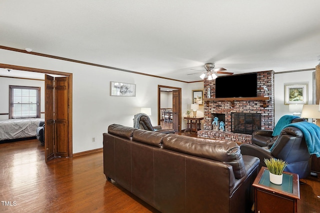203 Marlowe Dr, Dunn, NC 28334 - living area featuring ceiling fan, crown molding, a brick fireplace, wood finished floors, and baseboards