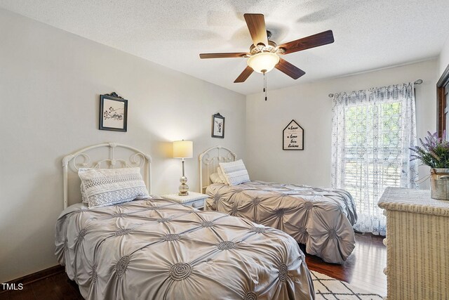 203 Marlowe Dr, Dunn, NC 28334 - bedroom with wood finished floors, a ceiling fan, and a textured ceiling