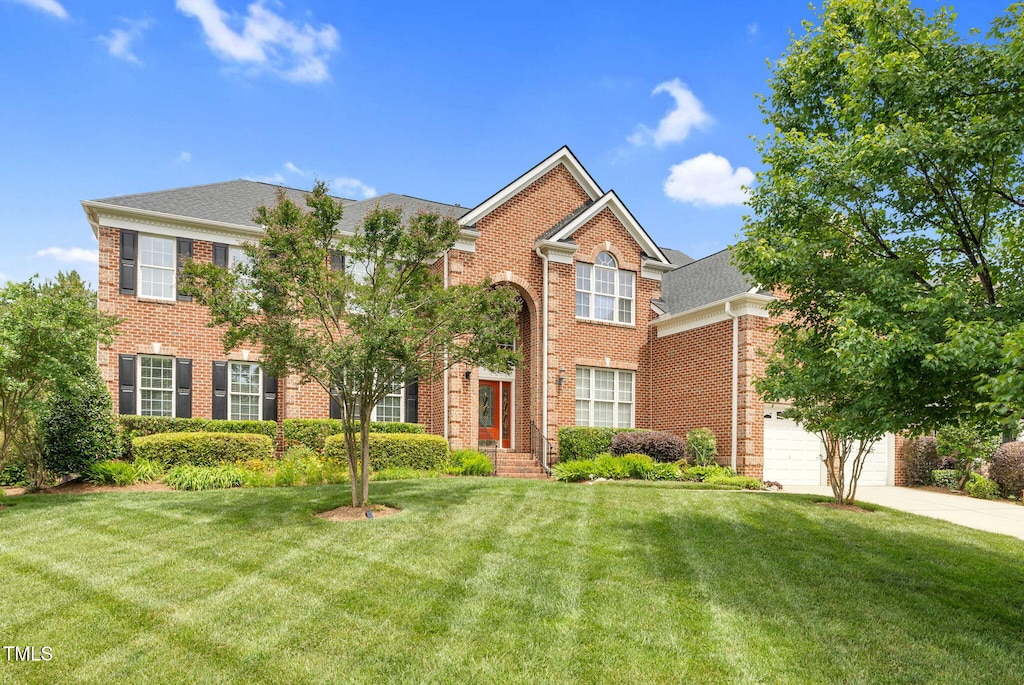 9639 Clubvalley Way, Raleigh, NC 27617 - view of front of home with brick siding, a front yard, and concrete driveway