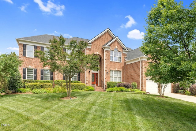 view of front of property featuring brick siding, a front yard, and concrete driveway