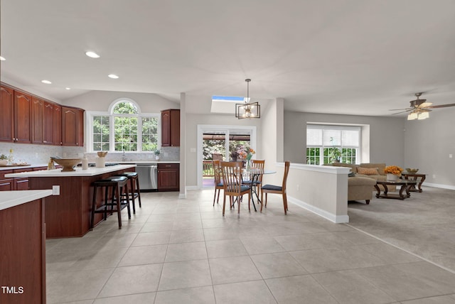 kitchen with light countertops, backsplash, stainless steel dishwasher, healthy amount of natural light, and recessed lighting