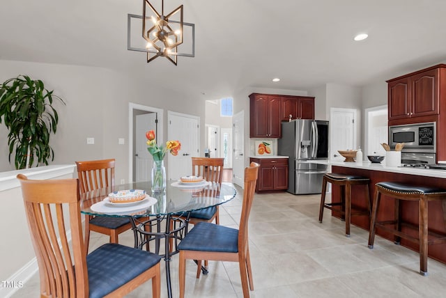 dining area with light tile patterned floors, recessed lighting, and a chandelier