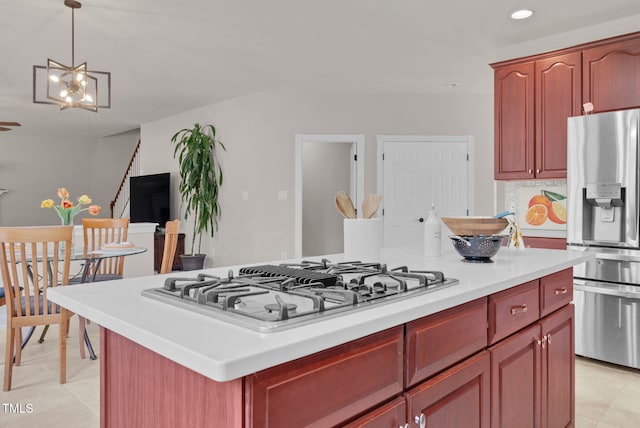 kitchen featuring stainless steel appliances, dark brown cabinets, a kitchen island, light countertops, and recessed lighting