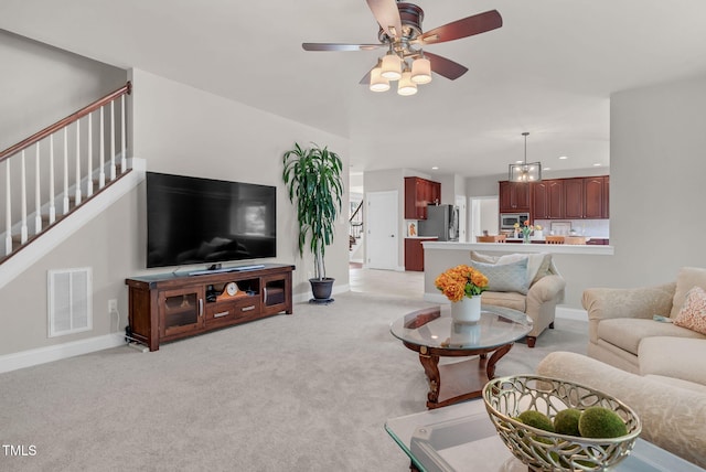 living room featuring stairway, light carpet, ceiling fan, recessed lighting, and baseboards