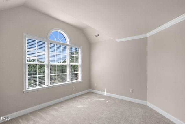 unfurnished room with lofted ceiling, light colored carpet, and baseboards