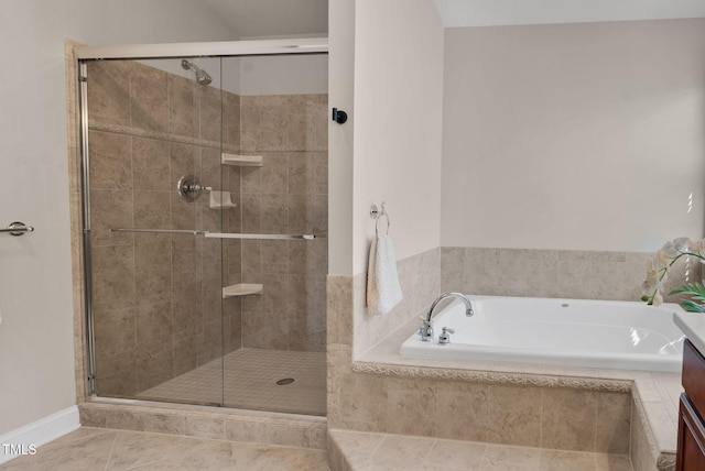 bathroom with a shower stall, a garden tub, and tile patterned flooring