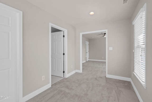 hallway with carpet flooring, baseboards, and recessed lighting