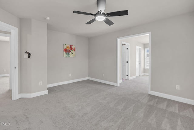 spare room featuring ceiling fan, carpet flooring, a smoke detector, and baseboards