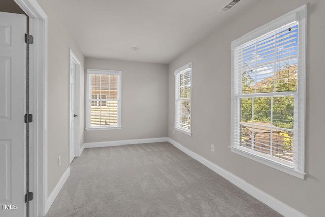 carpeted spare room with baseboards