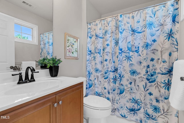 full bathroom featuring vanity, toilet, and curtained shower