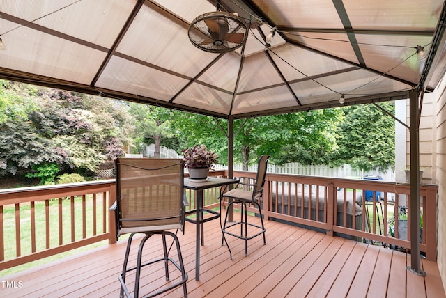 wooden deck with a gazebo and fence