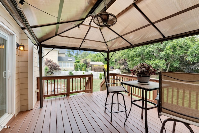 wooden deck featuring a gazebo and fence