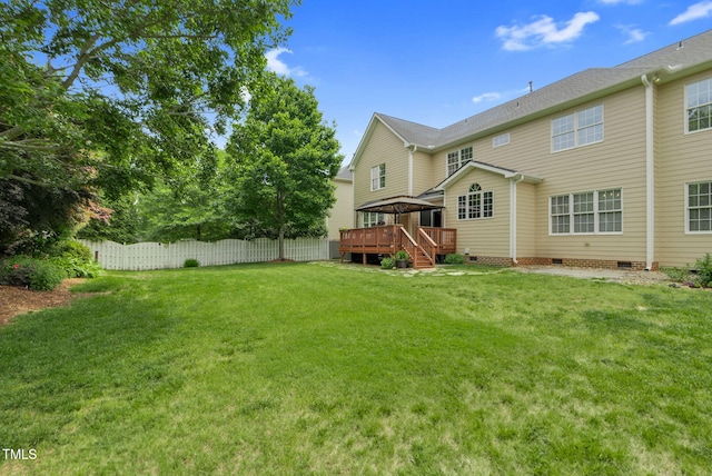 rear view of property featuring a gazebo, a deck, and crawl space
