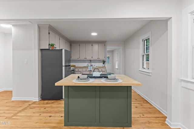 306 Coleman St, Oxford, NC 27565 - kitchen featuring freestanding refrigerator, light wood-style floors, a sink, baseboards, and recessed lighting