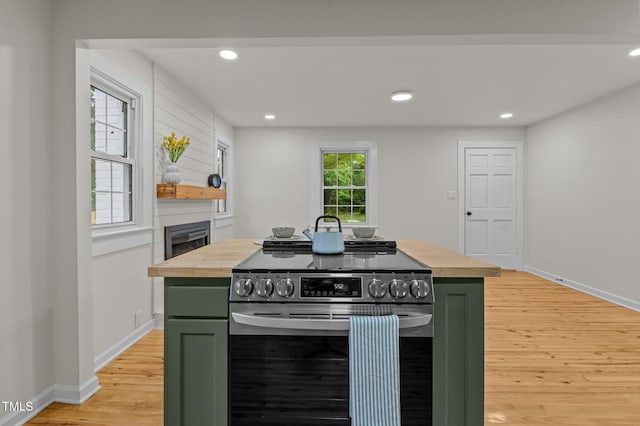 306 Coleman St, Oxford, NC 27565 - kitchen with green cabinets, stainless steel electric range oven, wood counters, light wood finished floors, and recessed lighting