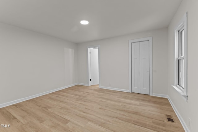306 Coleman St, Oxford, NC 27565 - unfurnished bedroom featuring light wood finished floors, baseboards, and a closet