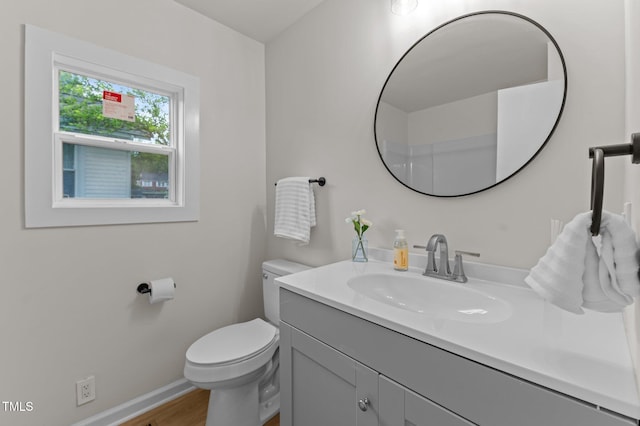 306 Coleman St, Oxford, NC 27565 - bathroom featuring toilet, vanity, baseboards, and wood finished floors