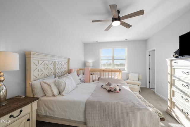bedroom featuring light colored carpet, ceiling fan, and baseboards