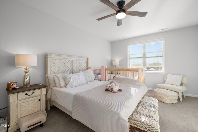 carpeted bedroom featuring baseboards and a ceiling fan