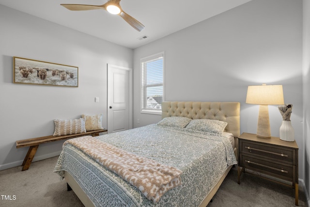 carpeted bedroom featuring baseboards and a ceiling fan