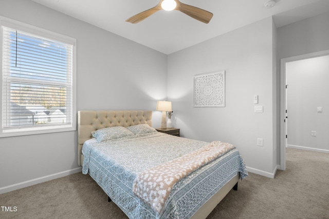 carpeted bedroom with baseboards and a ceiling fan