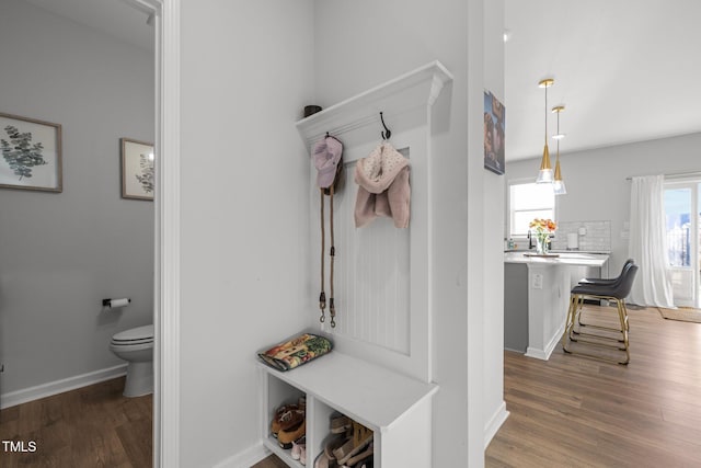 mudroom with wood finished floors and baseboards