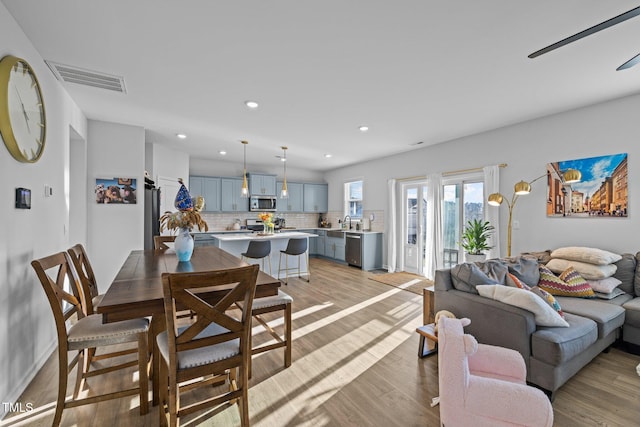 living room with light wood finished floors and recessed lighting