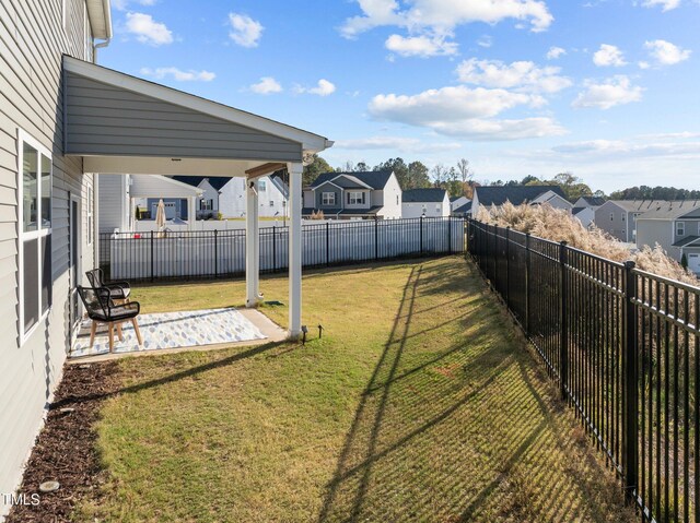 view of yard with a residential view and a patio