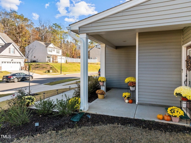 view of patio with a garage and a residential view