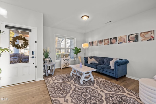 living area with wood finished floors and baseboards