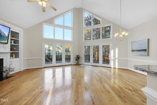 50 Tyler Ct, Henderson, NC 27537 - unfurnished living room with a chandelier, high vaulted ceiling, a ceiling fan, a fireplace with flush hearth, and hardwood / wood-style flooring