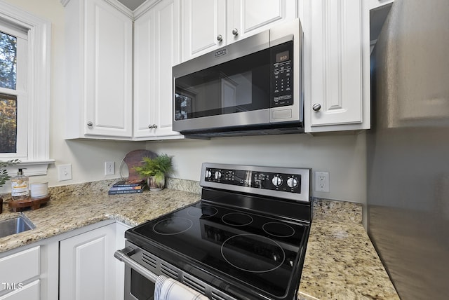 50 Tyler Ct, Henderson, NC 27537 - kitchen featuring stainless steel appliances, white cabinets, and light stone countertops
