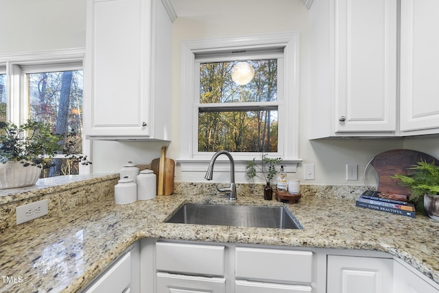 50 Tyler Ct, Henderson, NC 27537 - kitchen with a sink, white cabinetry, and light stone counters
