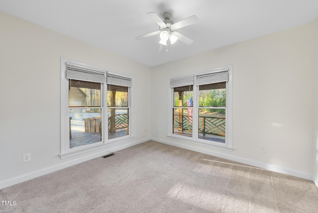 50 Tyler Ct, Henderson, NC 27537 - unfurnished room with healthy amount of natural light, carpet, baseboards, and a ceiling fan