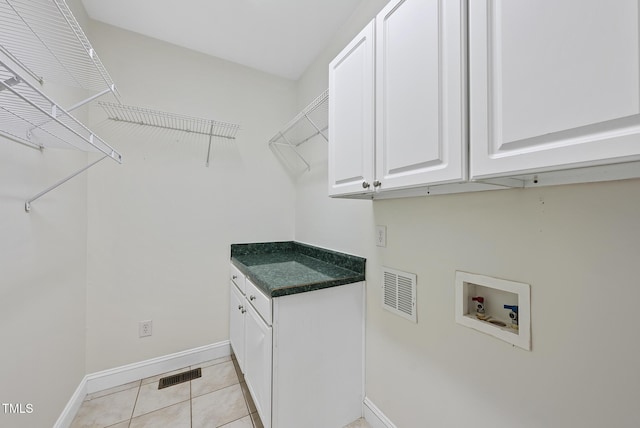 50 Tyler Ct, Henderson, NC 27537 - laundry area featuring hookup for a washing machine, cabinet space, baseboards, and light tile patterned floors